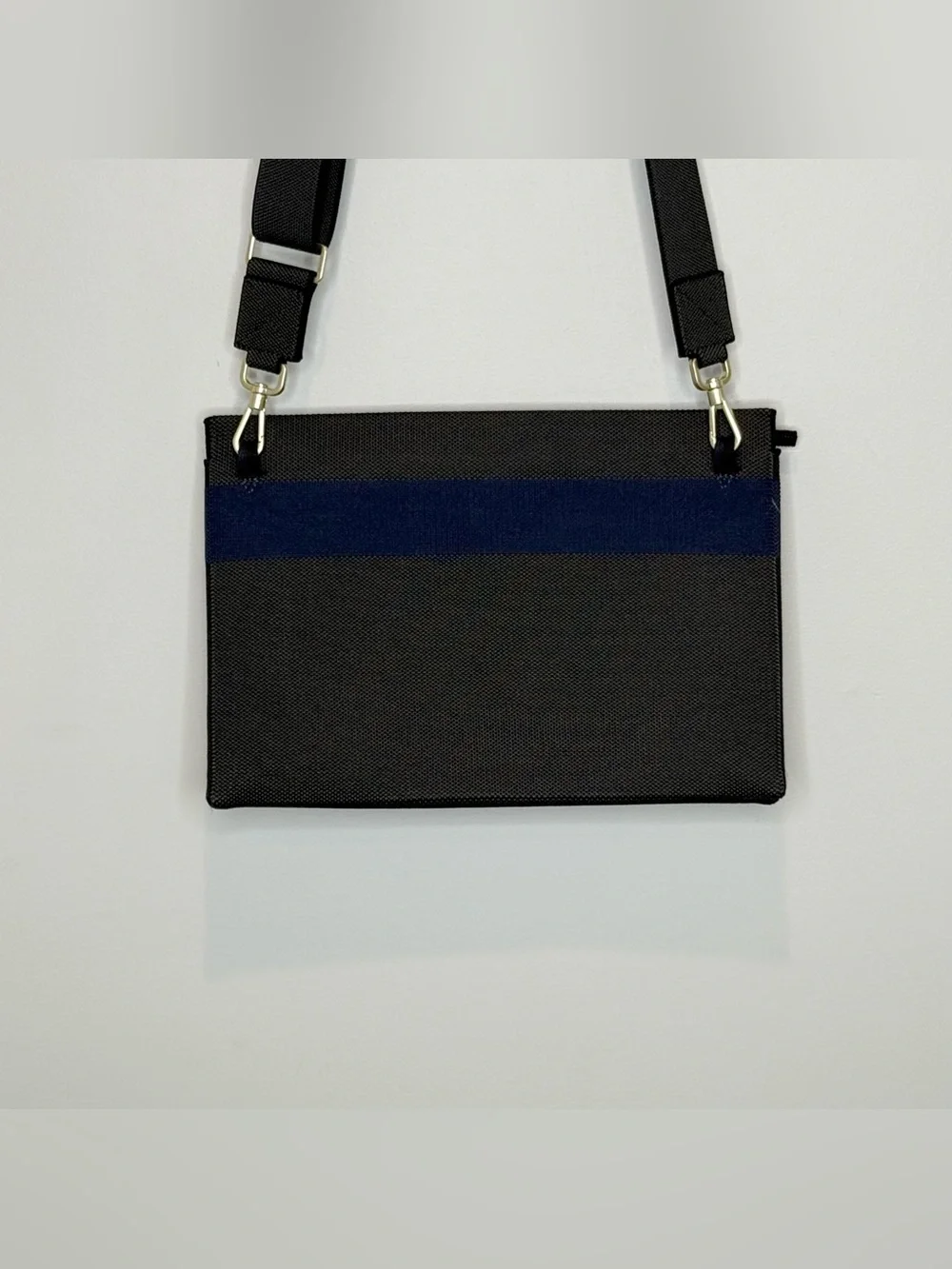 Rothy’s dark gray and blue fabric crossbody clutch or shoulder bag